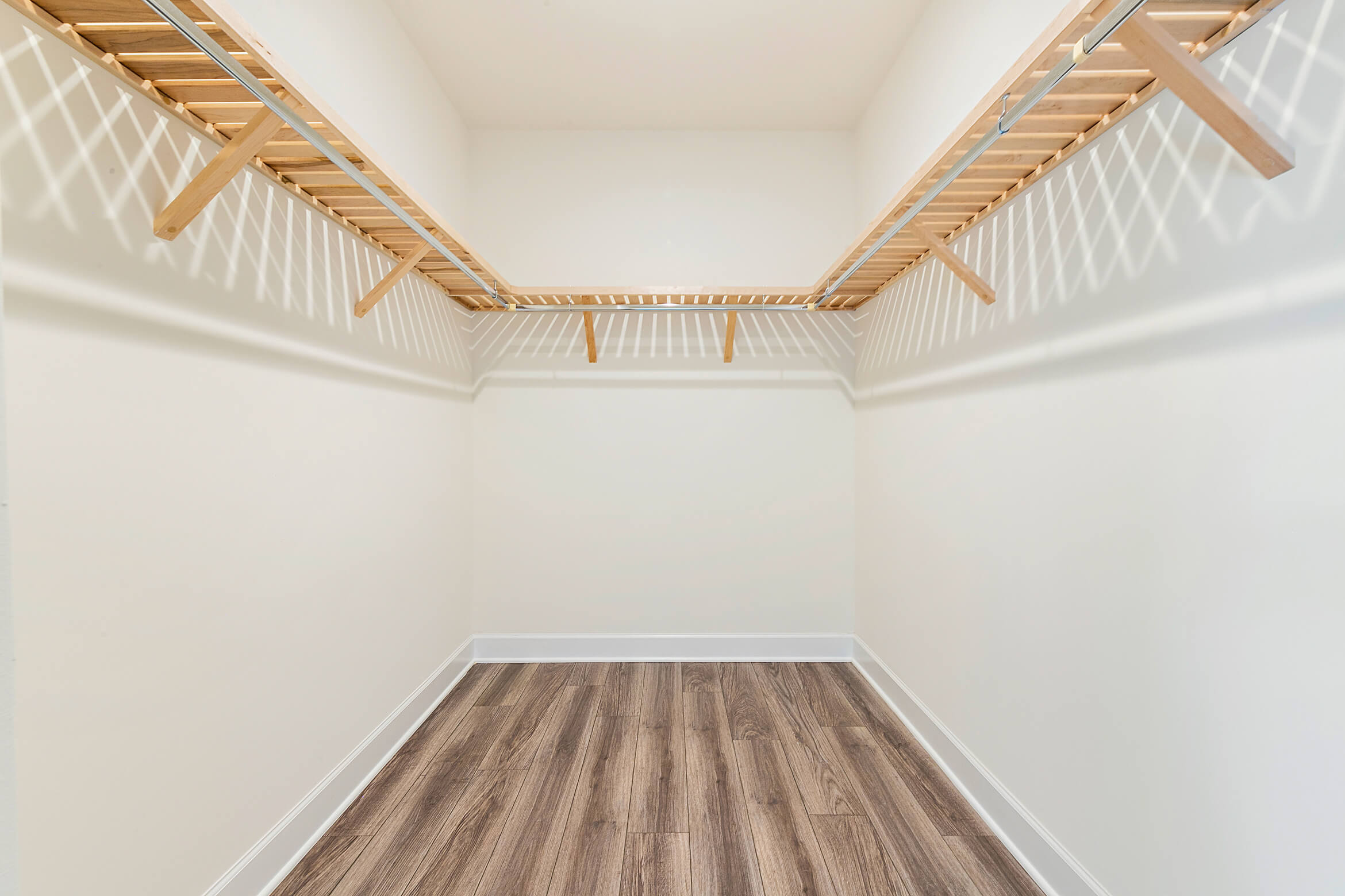 Walk in closet with wooden storage