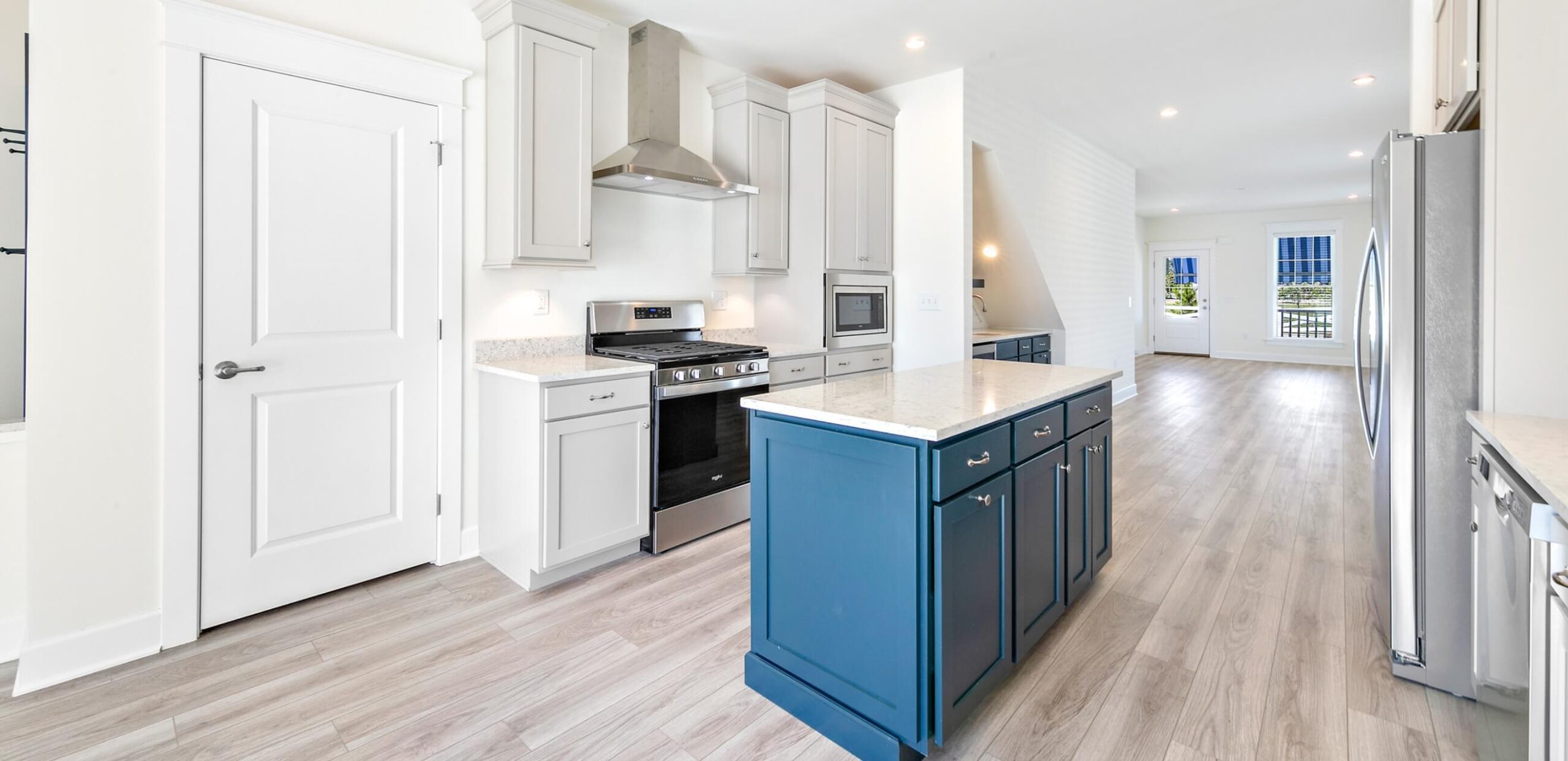 White kitchen with a blue center island