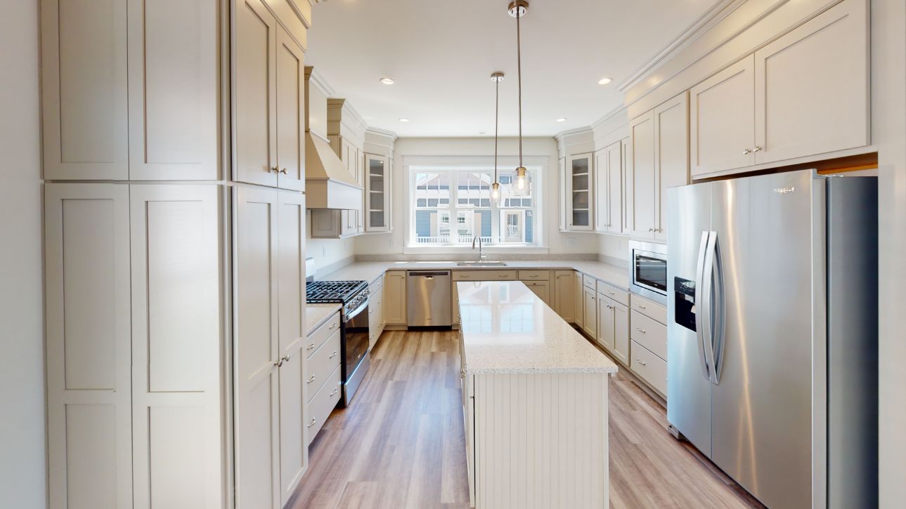 Cream colored kitchen with stainless steel appliances